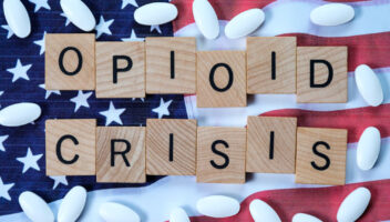 American flag with pills around wording saying 'opioid crisis'